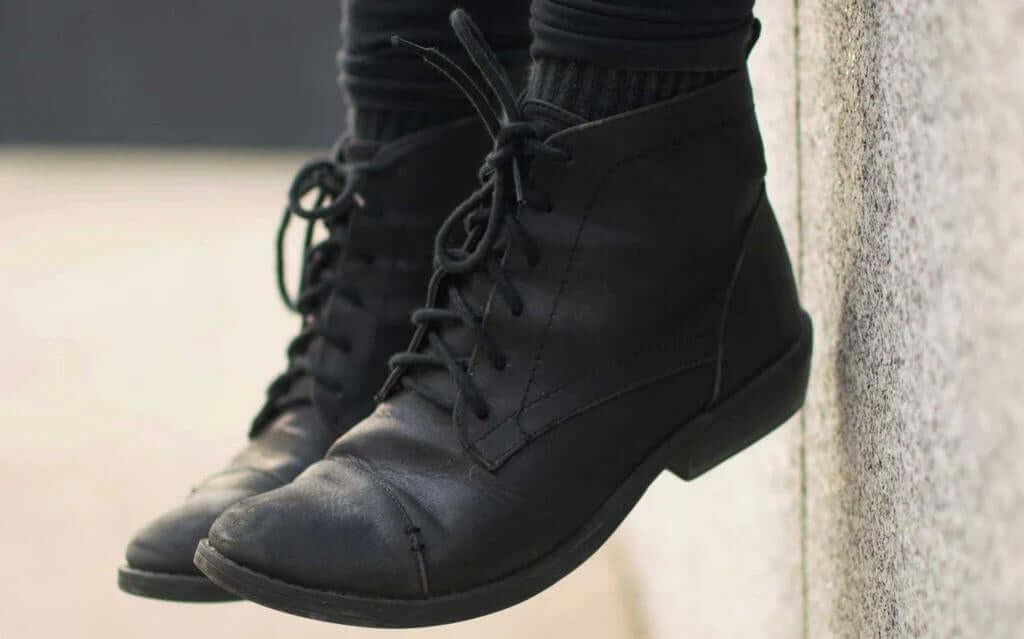 black leather boots showing well maintained leather surface after cleaning and conditioning