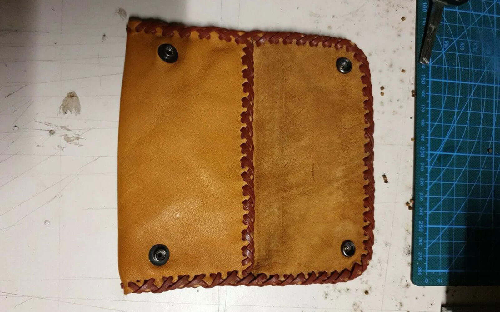Handmade leather wallet showing double loop leather edge lacing