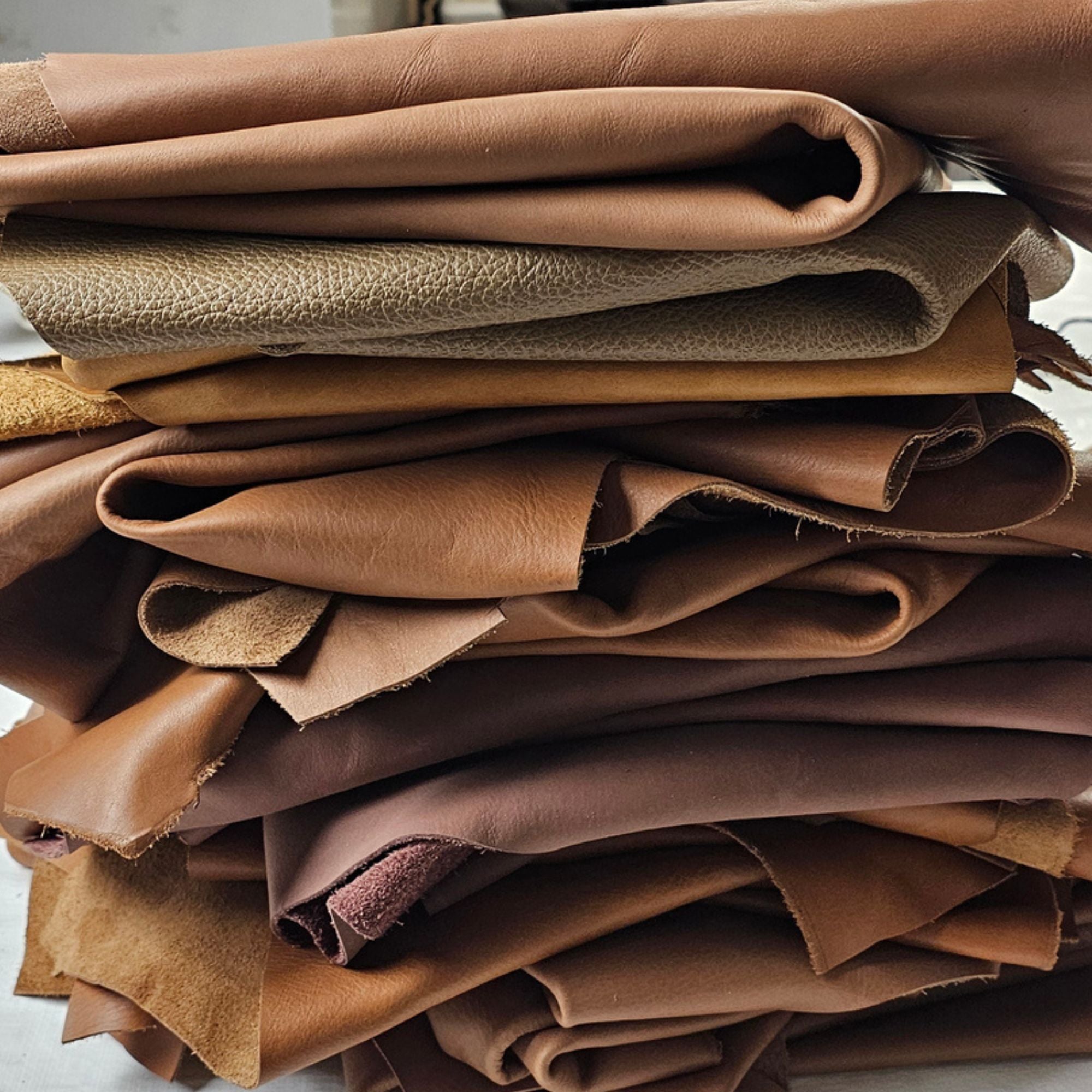 Brown leather remnants in assorted 1–2 sq ft cowhide pieces