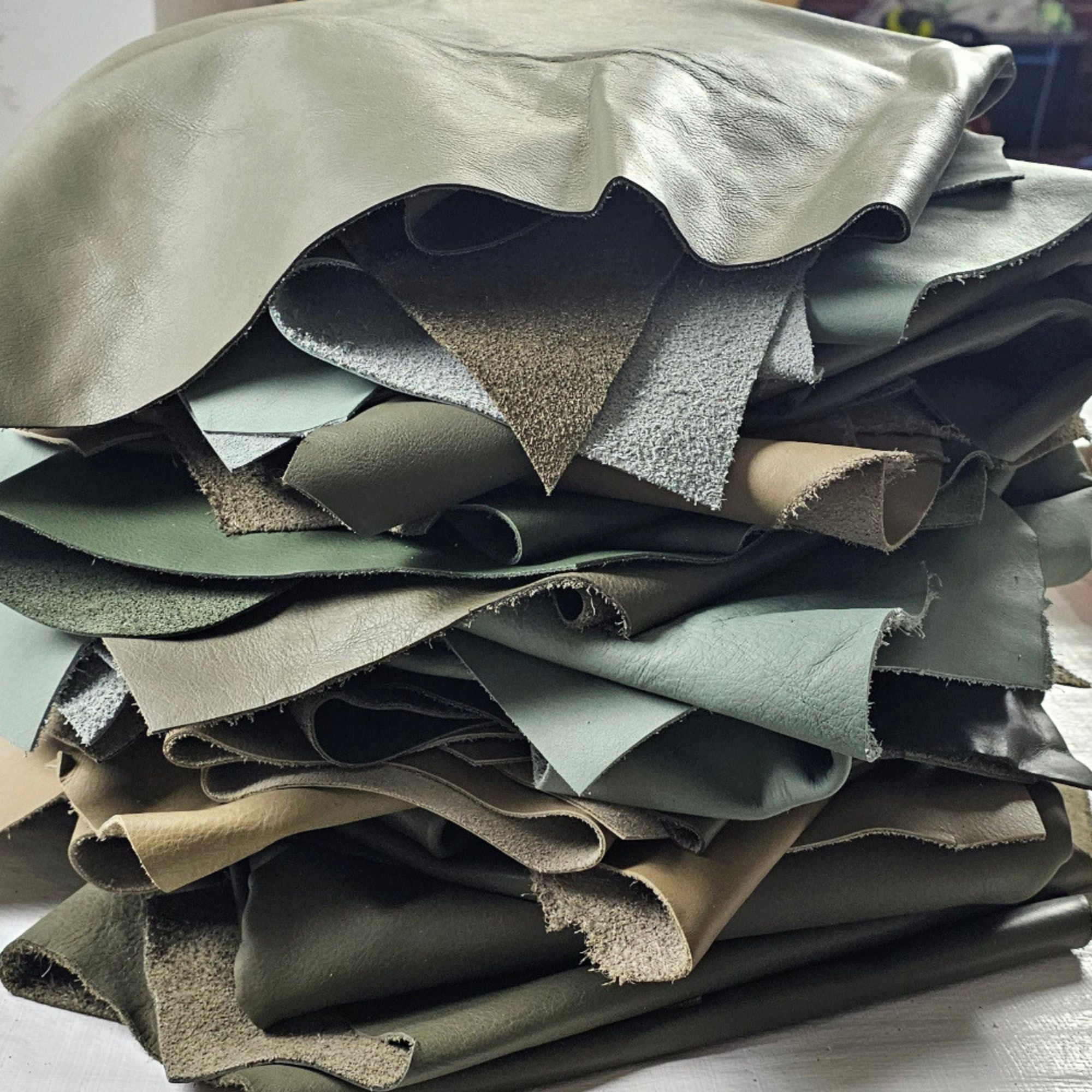 Assorted green full-grain cowhide leather pieces in 1–2 sq ft sizes