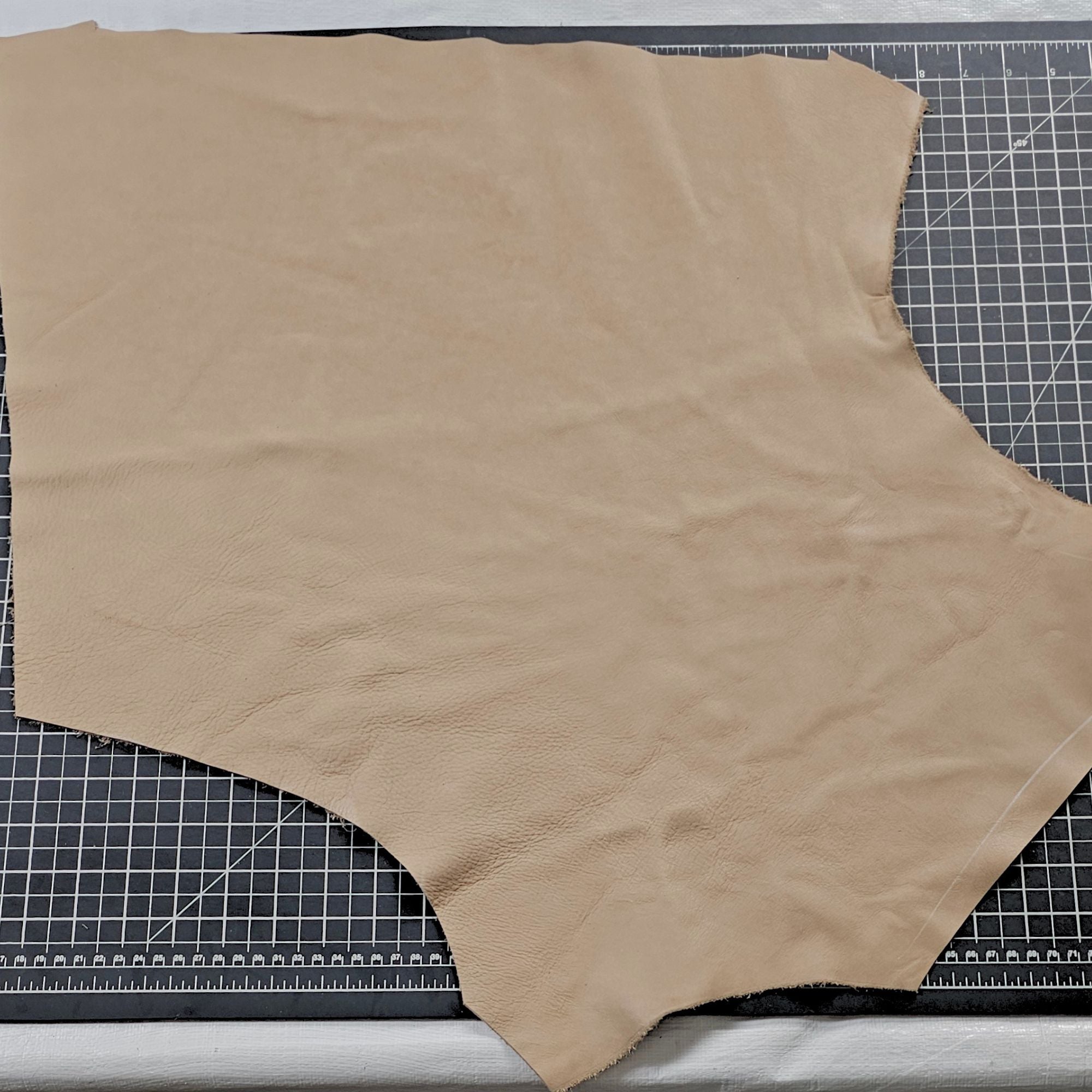 Taupe full-grain cowhide leather piece measuring approximately 1–2 sq ft