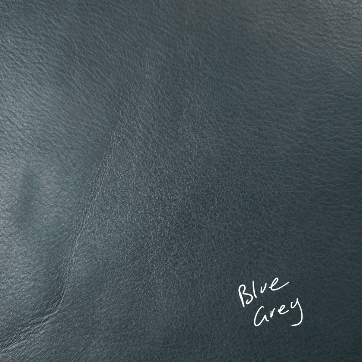 Blue grey cowhide leather piece showing natural grain and texture