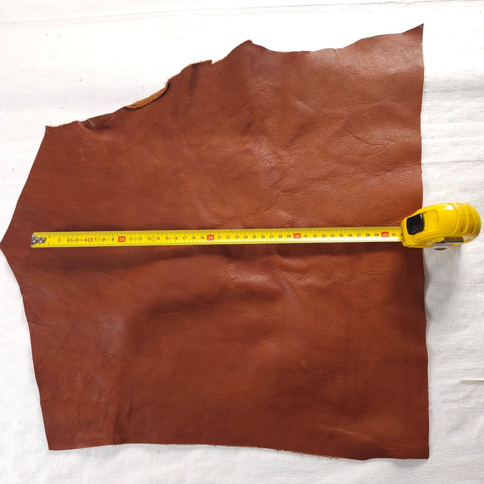 Vegetable-tanned leather scraps in Forest Green and Tan, varying shapes and textures.