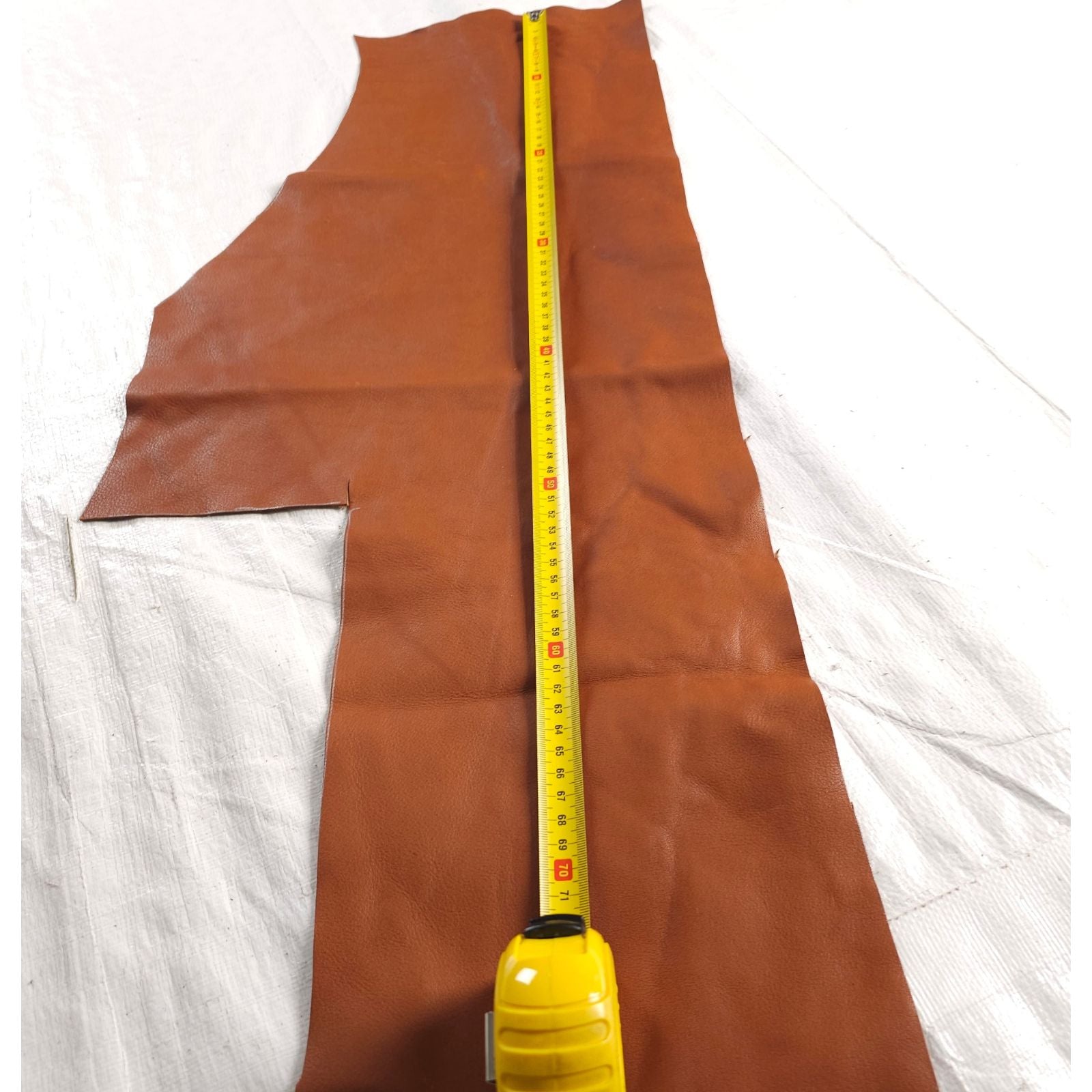 Brown veg tan leather piece measured vertically