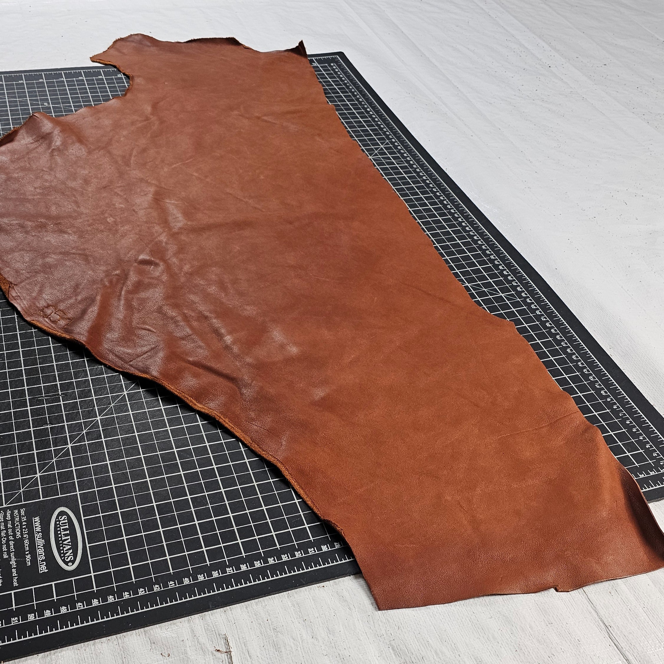 Brown veg tan leather piece measured vertically