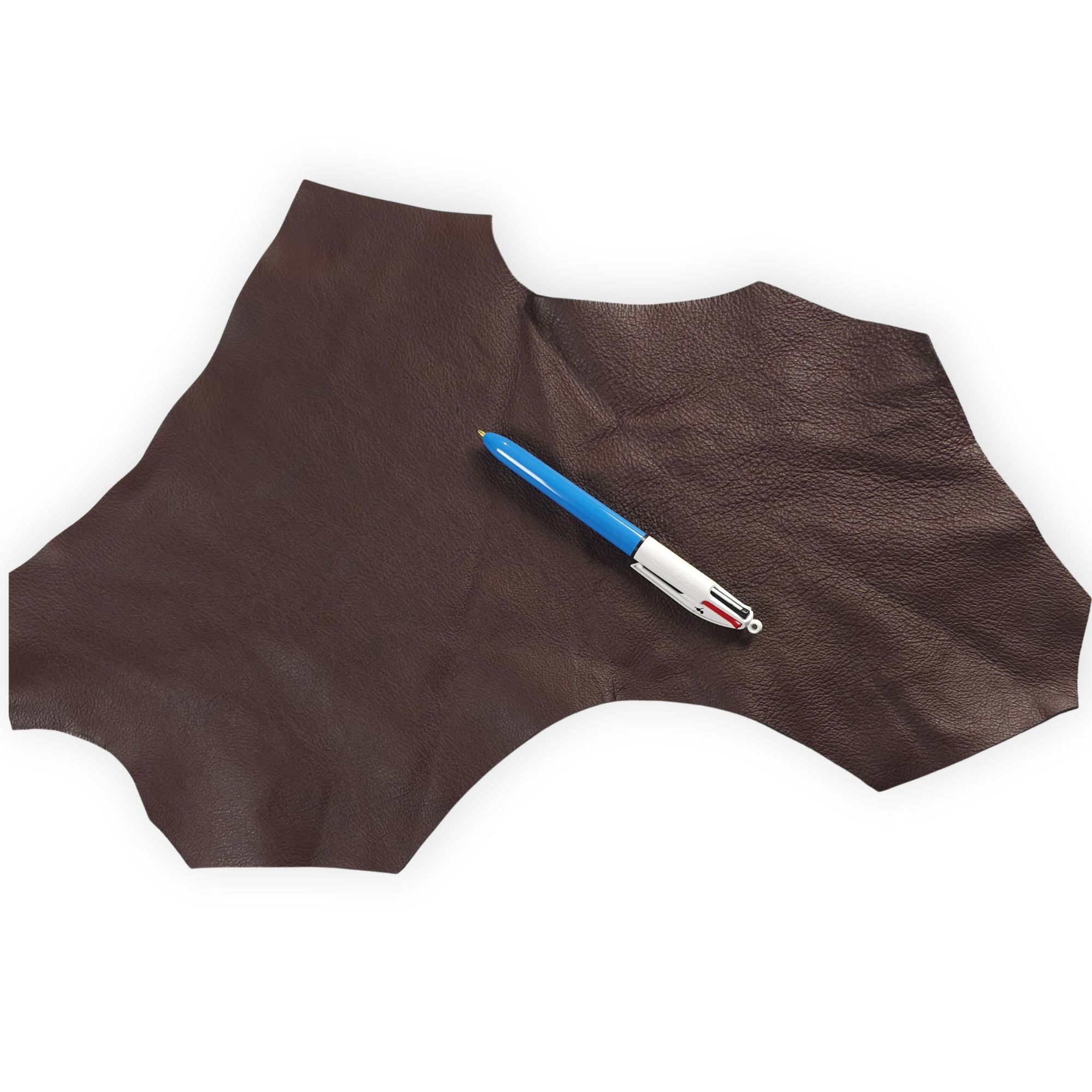 Flexible chocolate brown leather scrap with pen for size reference