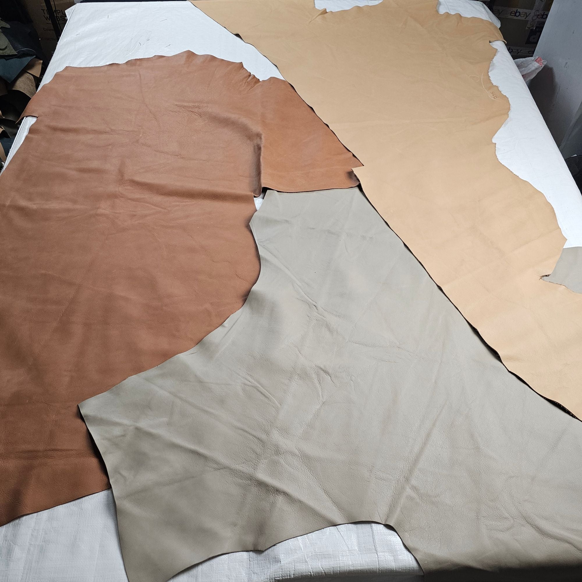 Large upholstery leather offcuts in beige, taupe and brown shades