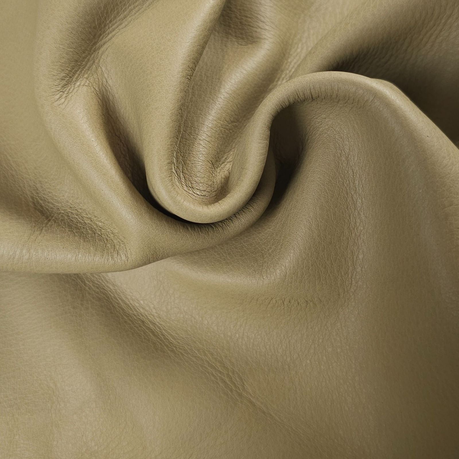 Close-up of khaki-green leather large  piece with folds