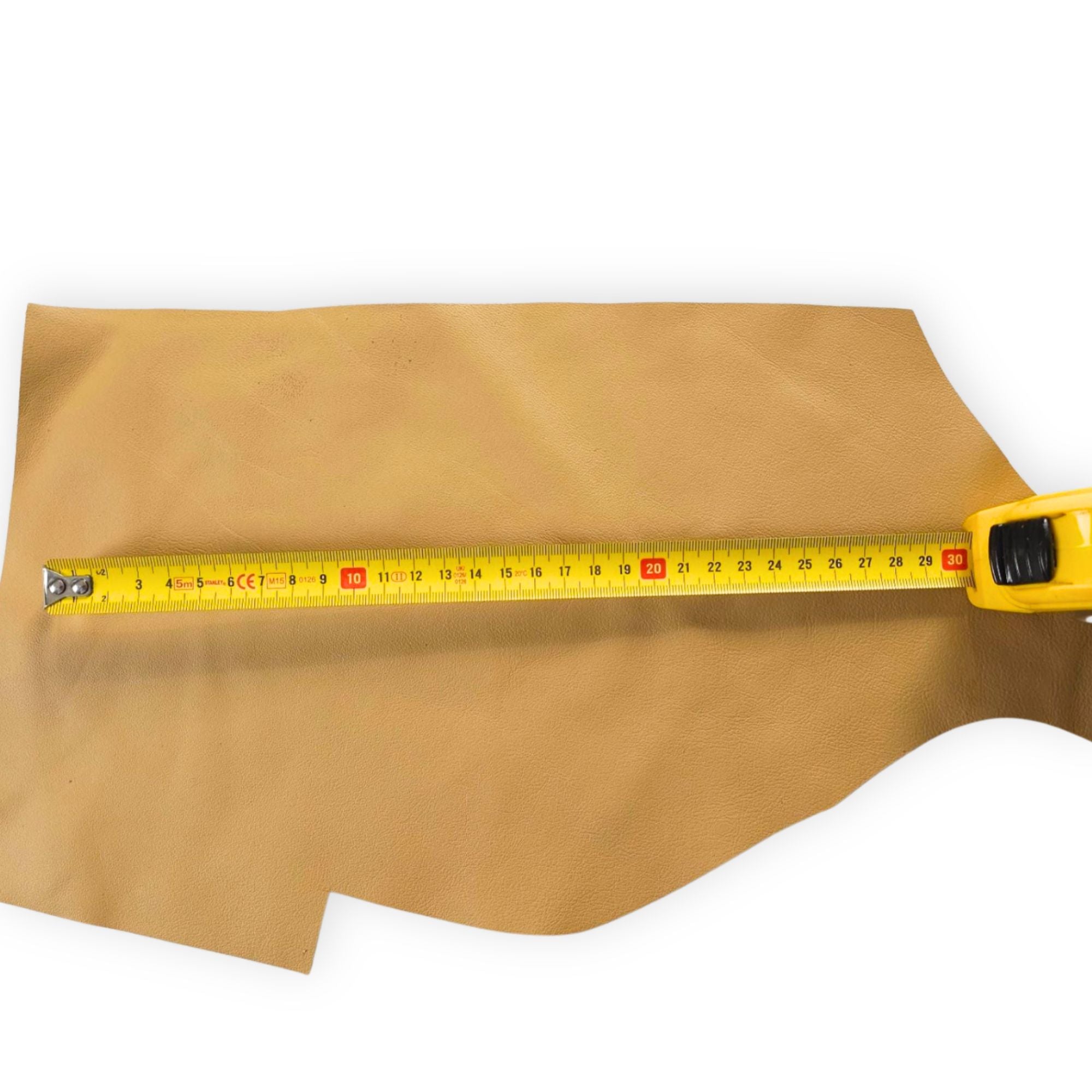 Mustard tan cowhide leather scrap shown with measuring tape