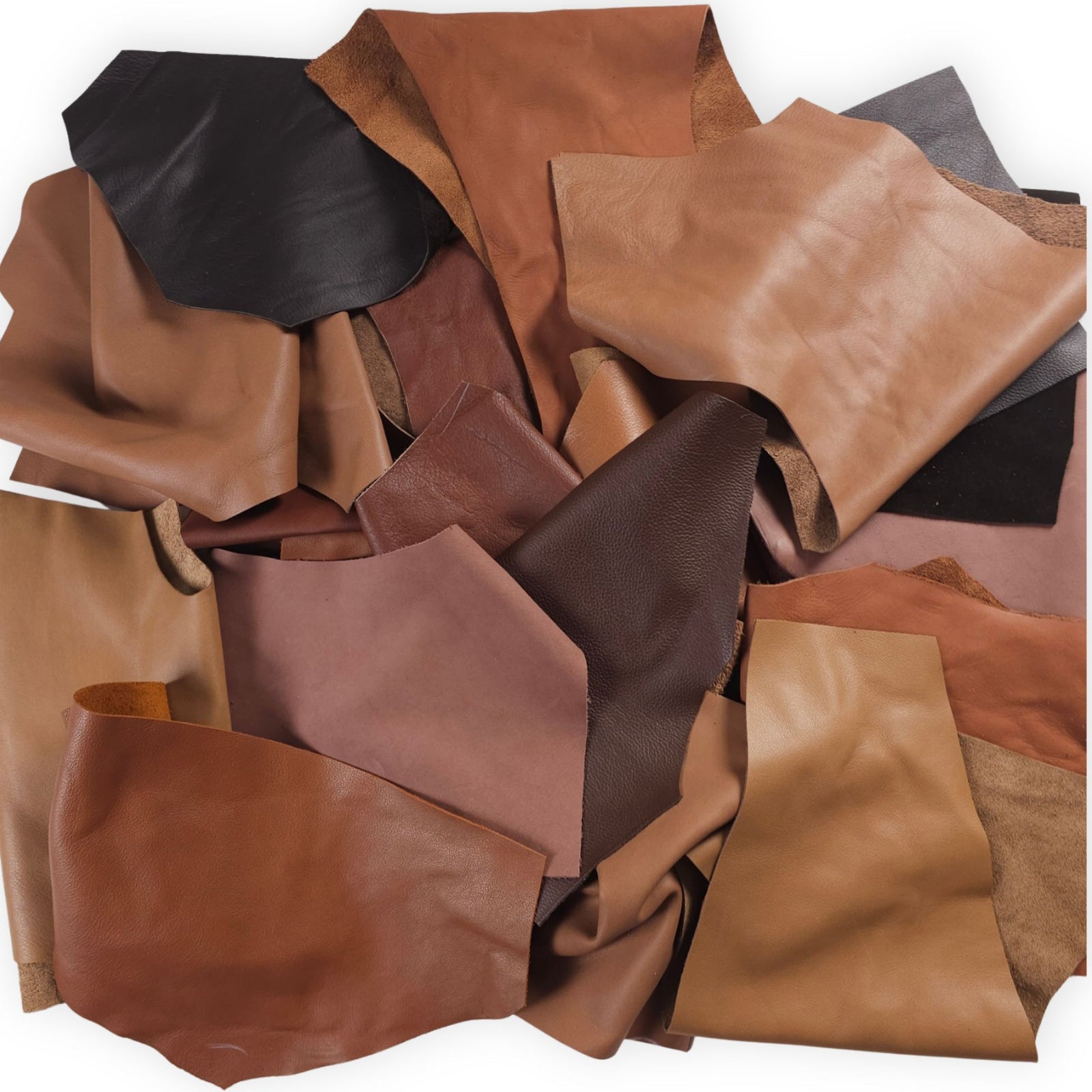 Assorted brown leather scraps in 1–3 hand-sized pieces