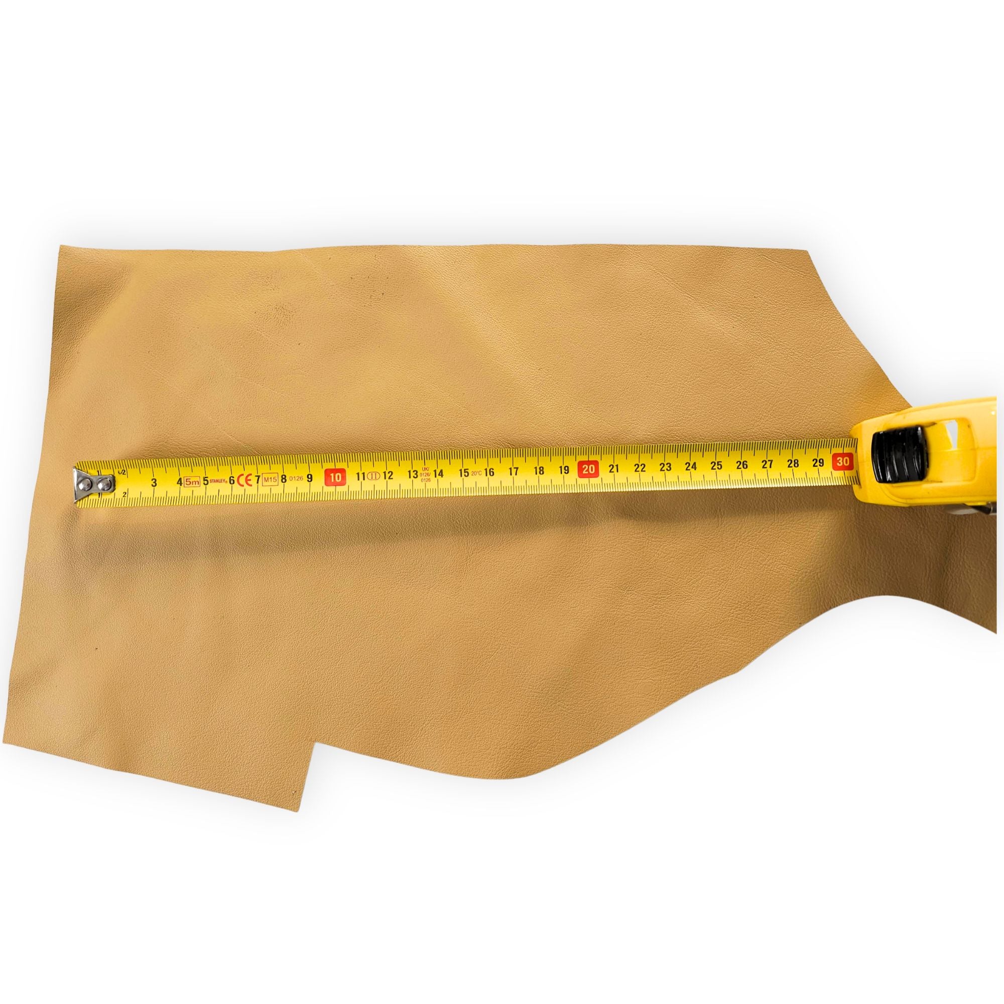 Tan leather offcut shown with measuring tape for size