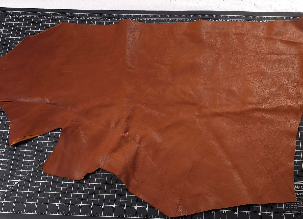 Reddish-brown full-grain cowhide offcuts for bags and craft projects