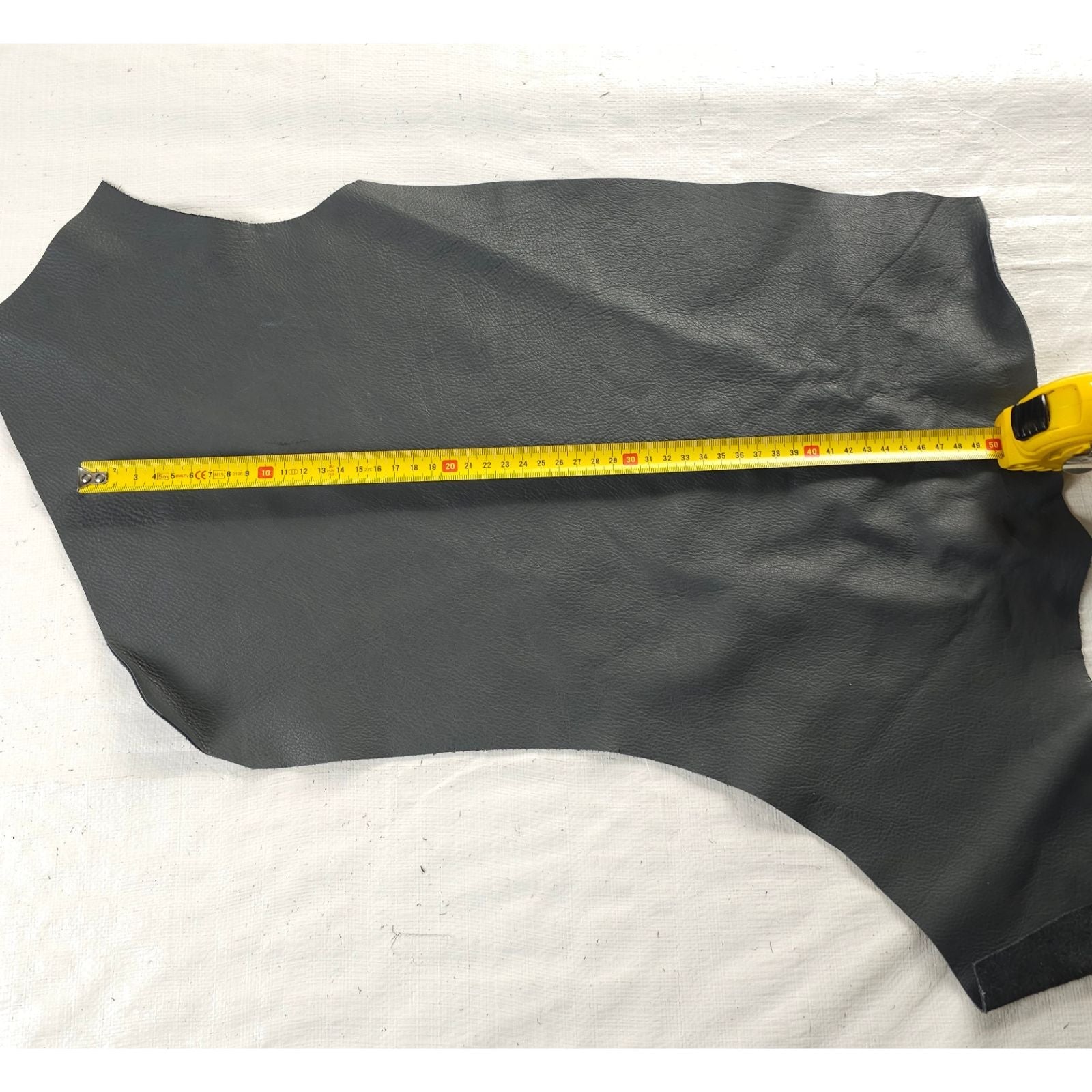 Charcoal grey leather offcut shown with measuring tape
