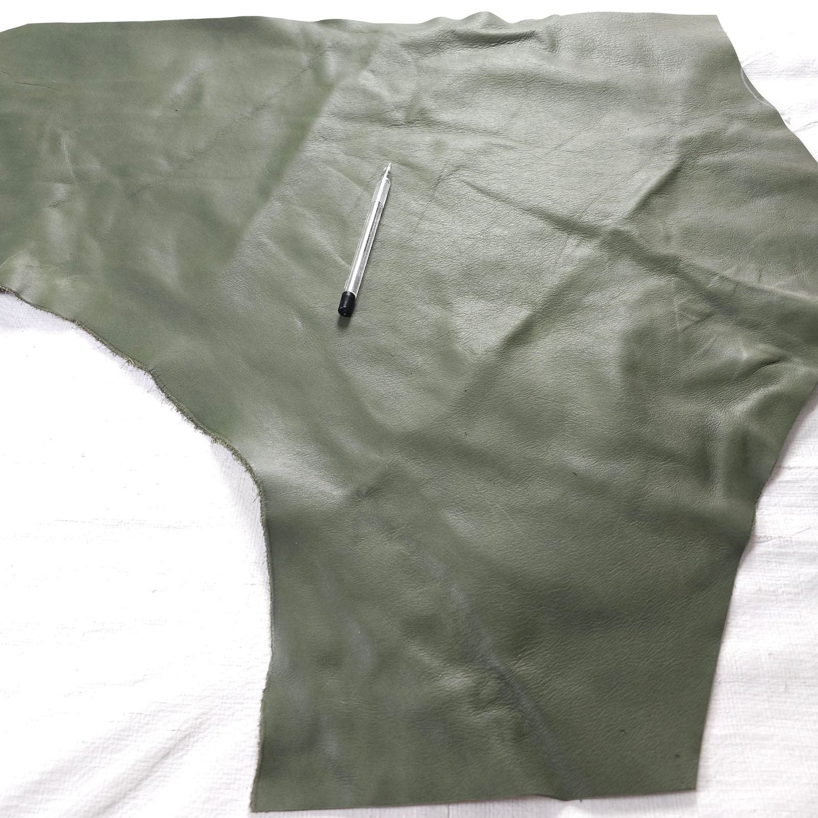 Medium green leather remnant irregular shape 1 to 2 sq ft