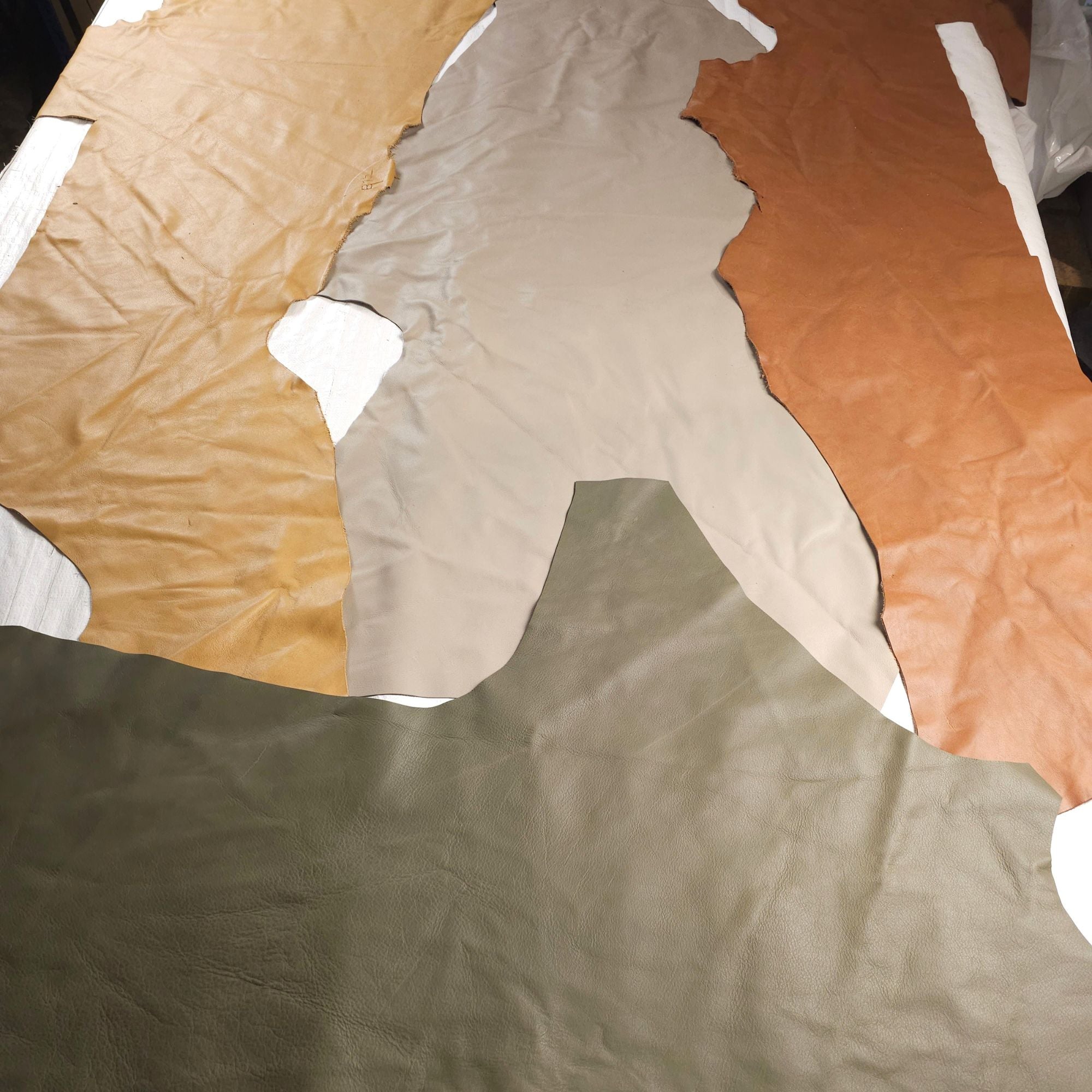 Earth tone leather offcuts in tan, cream, brown and olive green