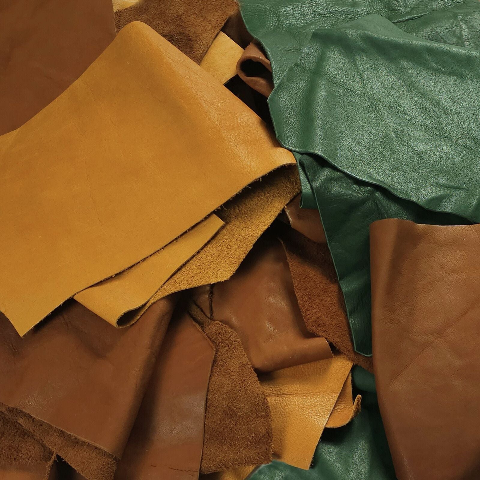 Mixed veg tan leather pieces in brown and green tones