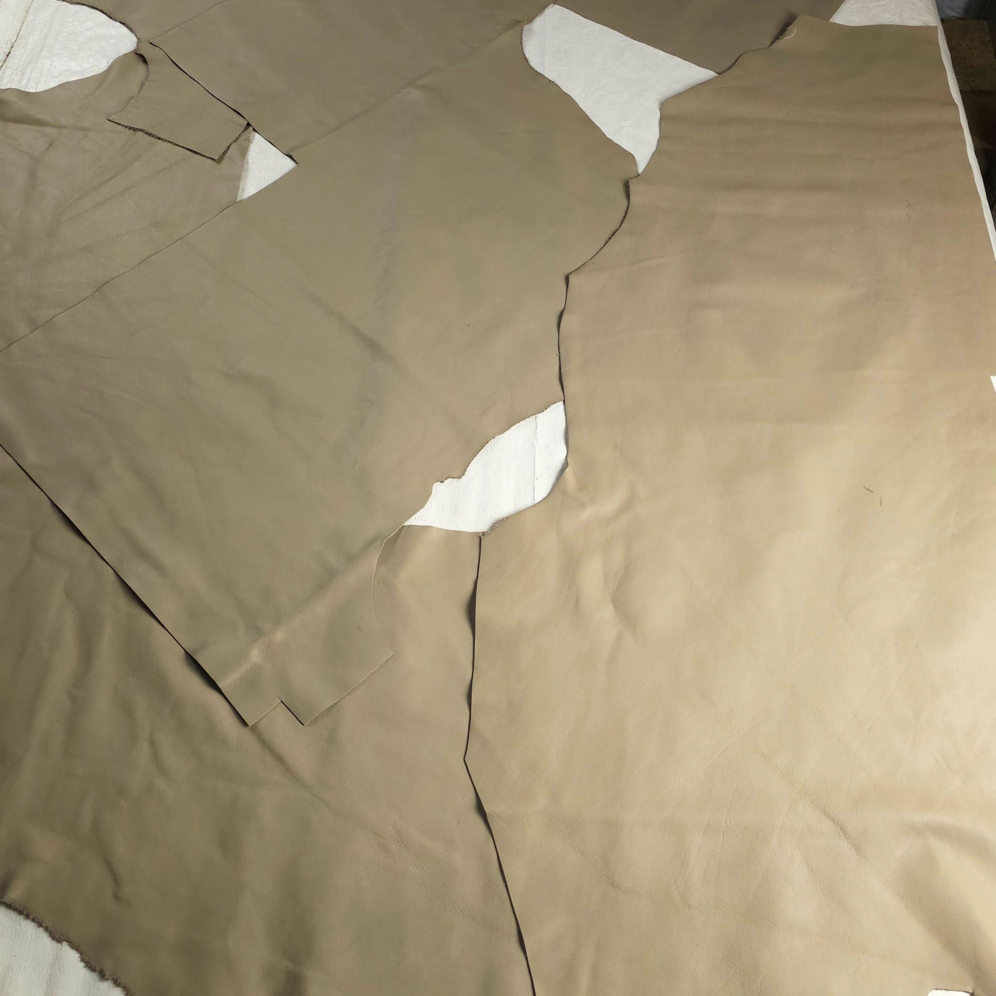Large sage-green leather upholstery pieces with natural irregular shapes