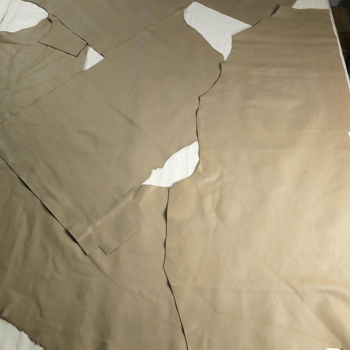 Large sage-green leather upholstery pieces with natural irregular shapes