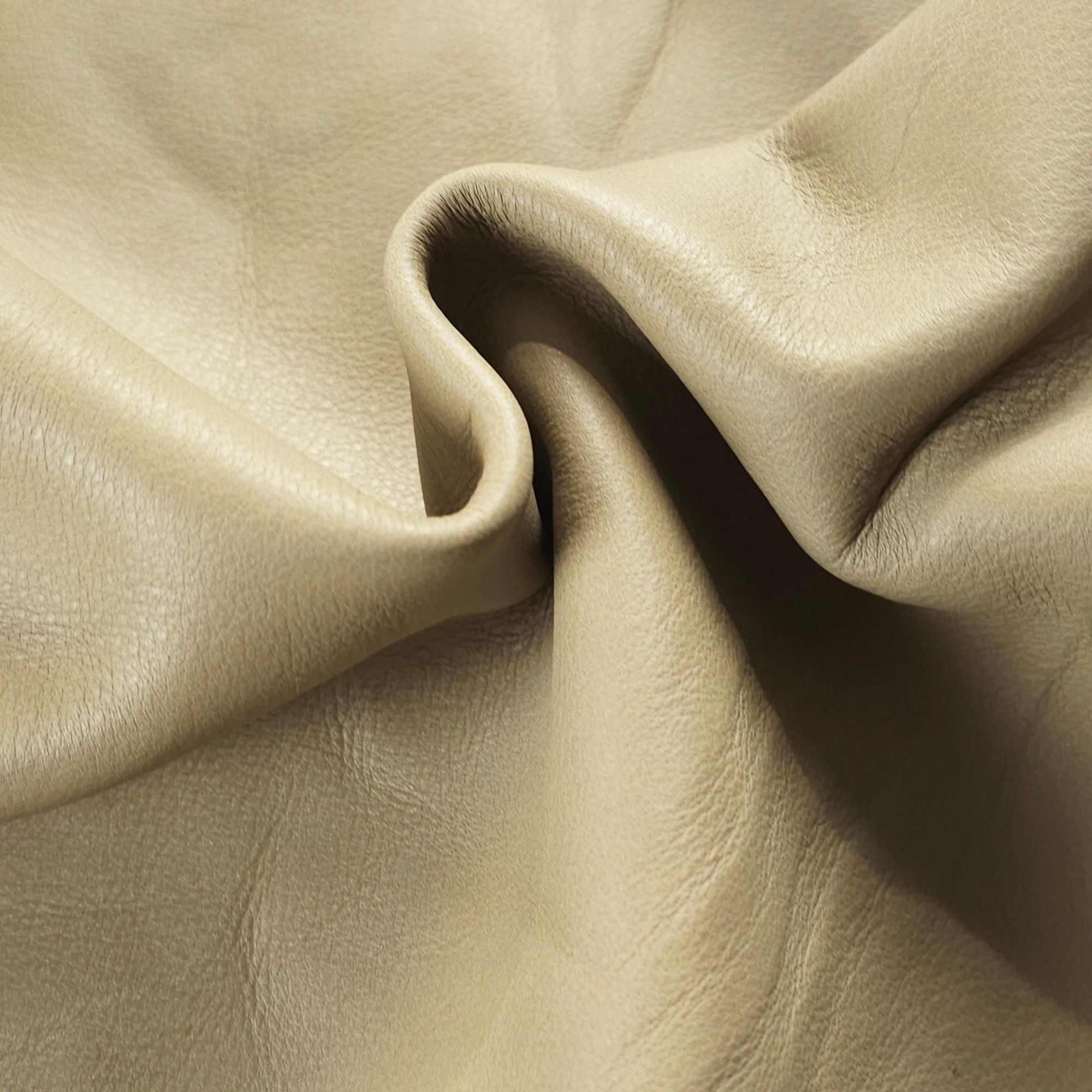 Close-up of soft sage green upholstery leather grain and texture