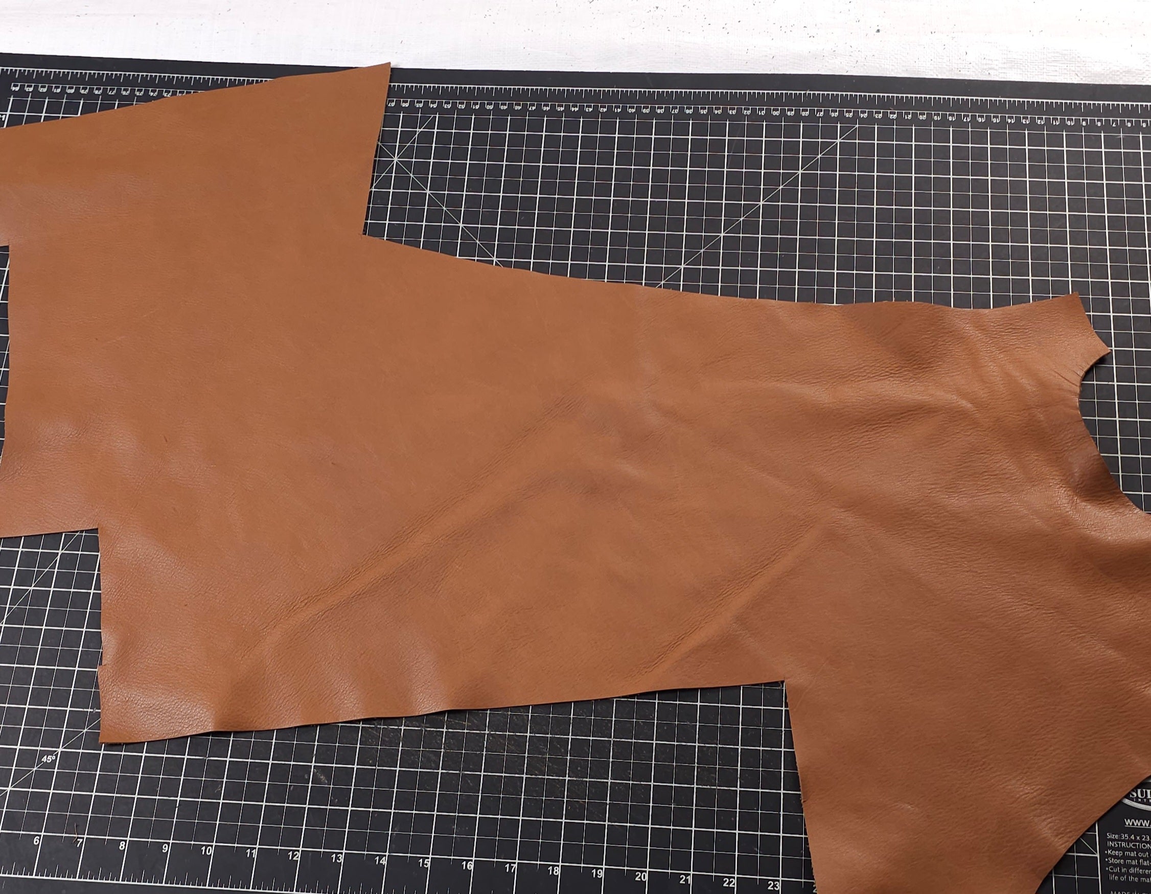 Soft brown full-grain leather remnant showing natural texture