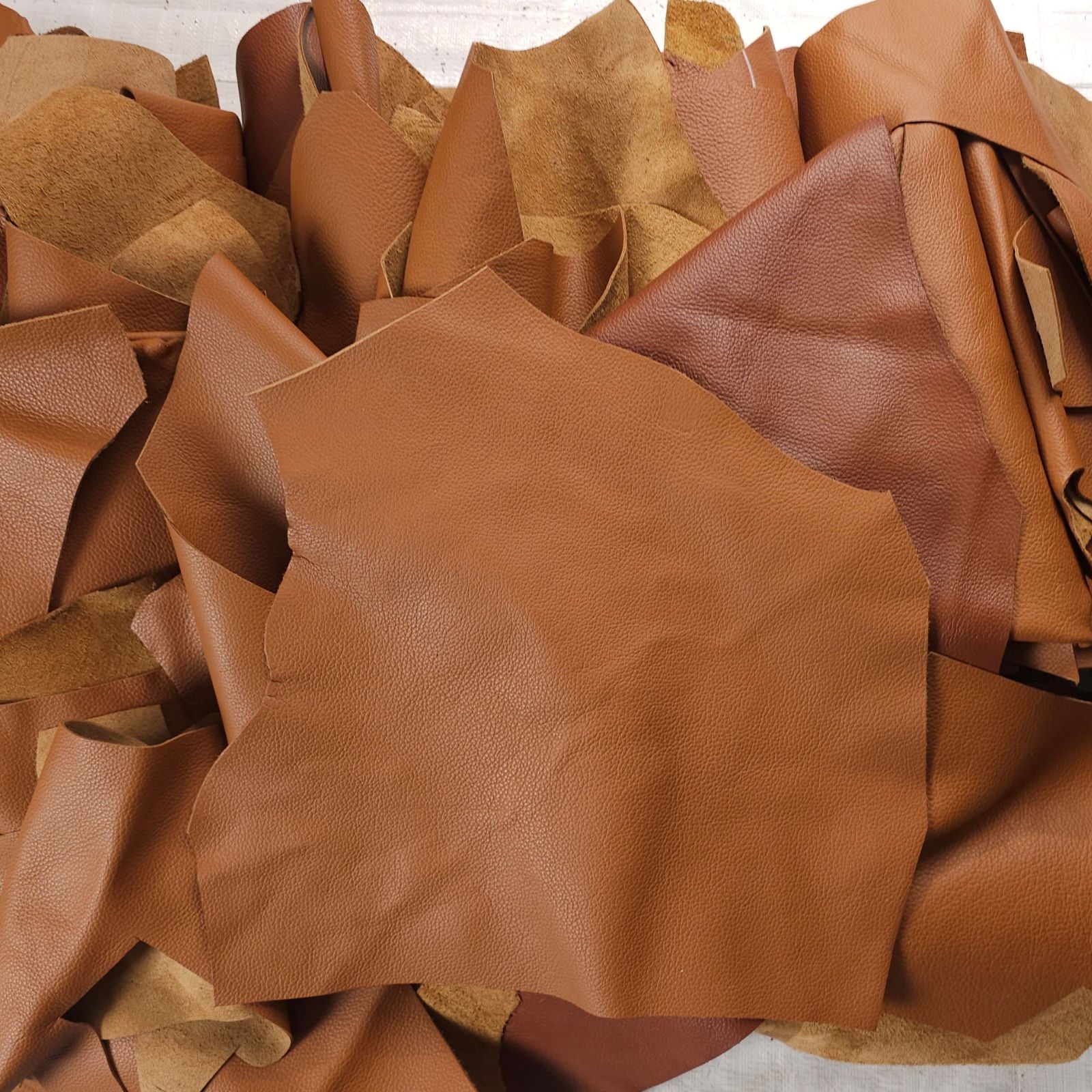 Tan leather scraps 1 to 3 hands grainy texture