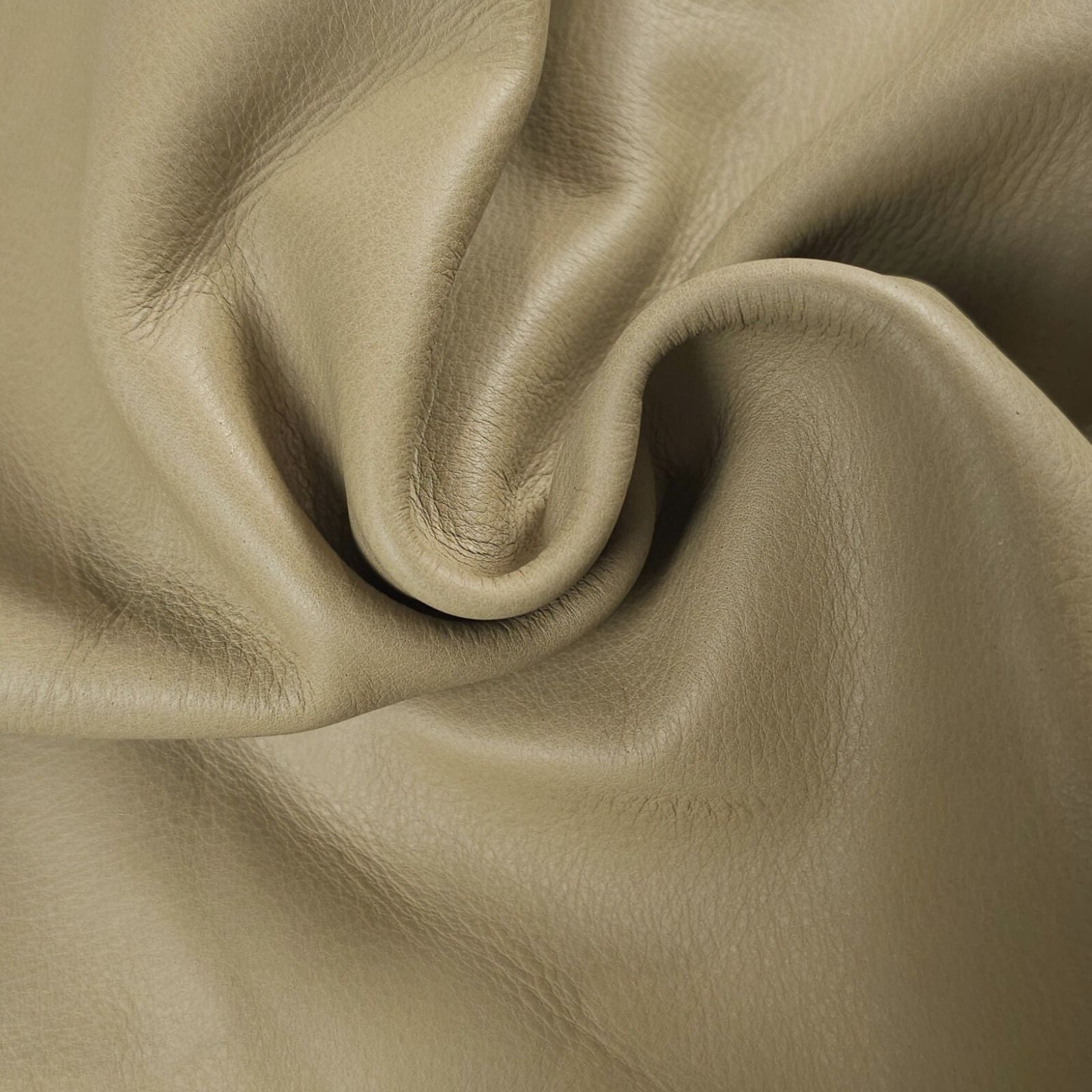 Large chrome tanned upholstery leather close up khaki-green drape