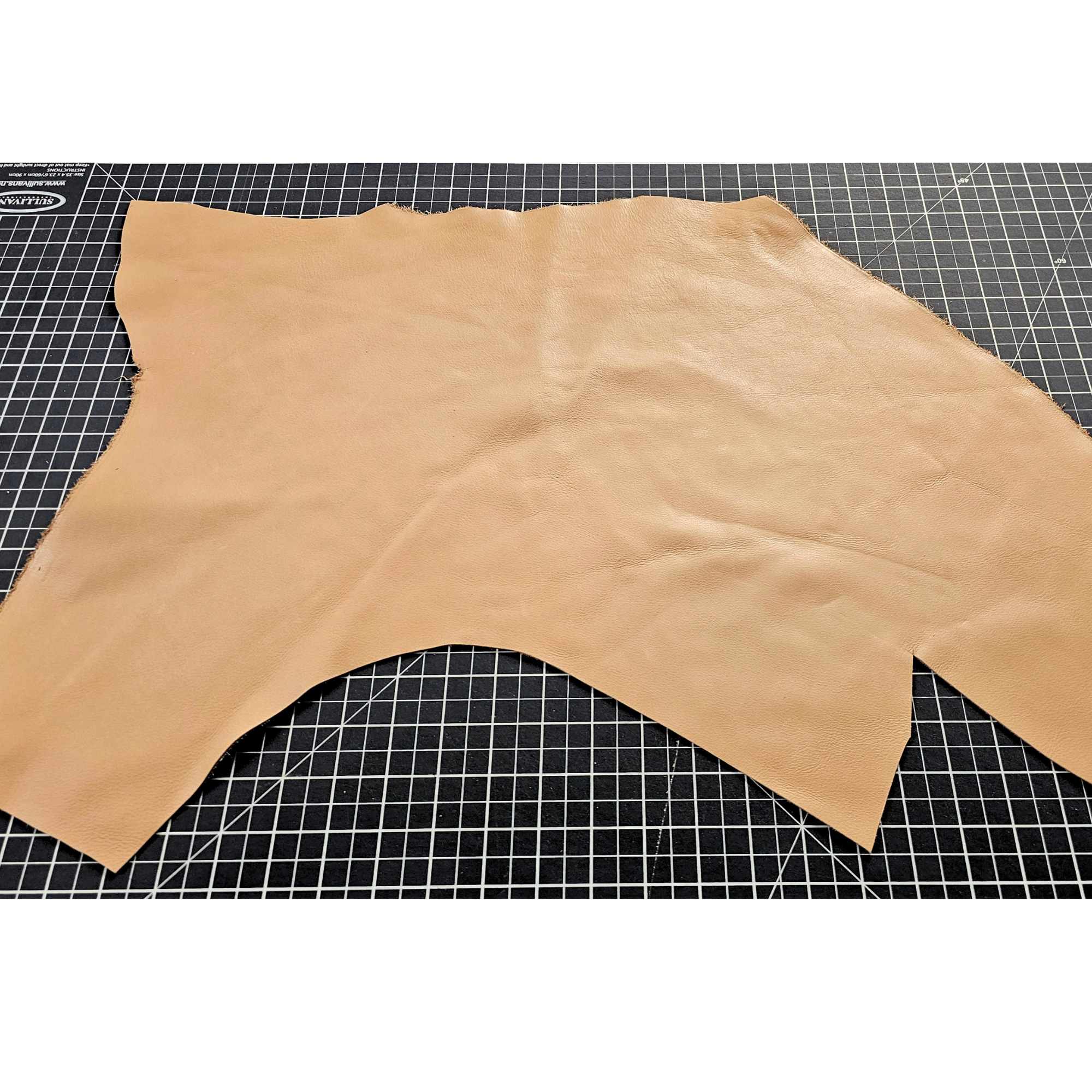 Tan full-grain cowhide leather piece showing natural shape and grain