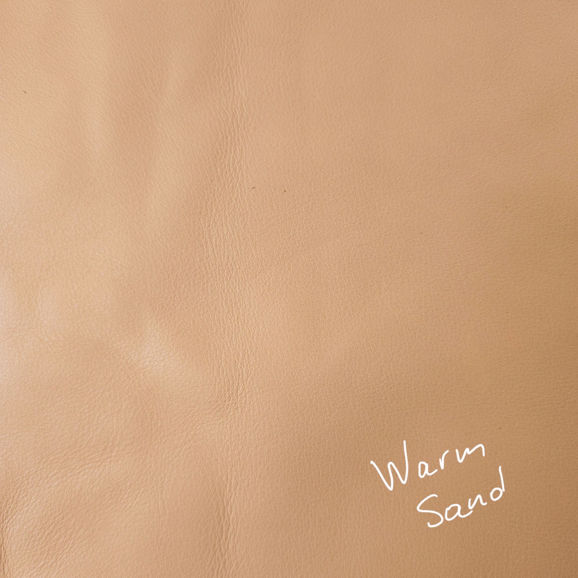 Warm sand cowhide leather piece showing natural tonal variation